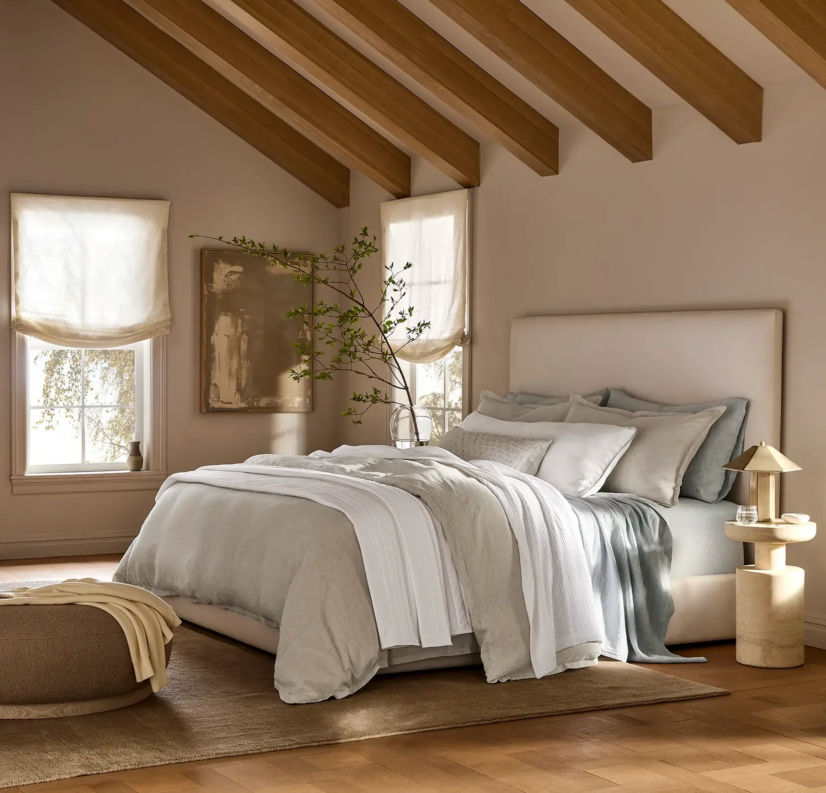 Bed styled with a natural linen duvet set in a calm bedroom