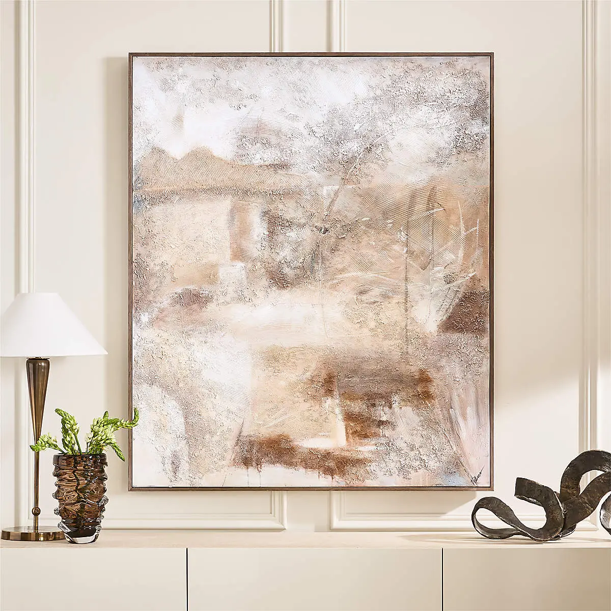 Large framed sculptural art piece above a bed