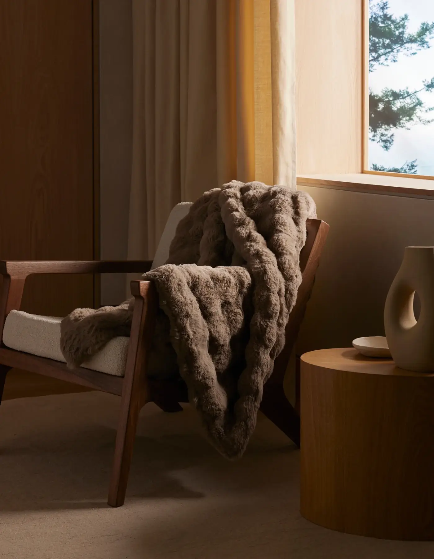 Textured bubble knit throw blanket folded at the foot of a bed
