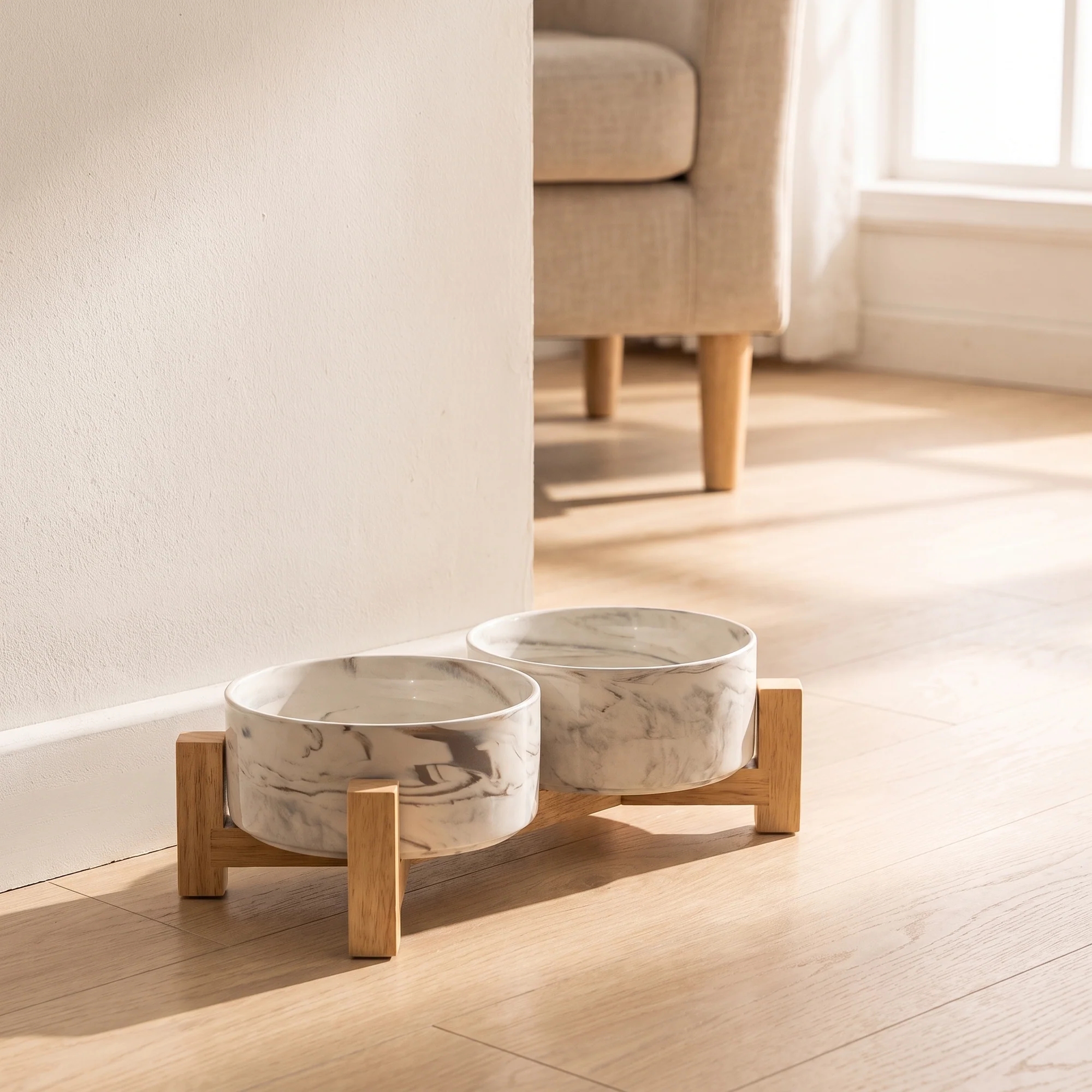 Carrara marble pet bowl set styled on a kitchen counter