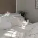 Neutral linen bedroom bathed in warm morning light