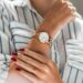 Woman's wrist wearing an elegant gold minimalist watch